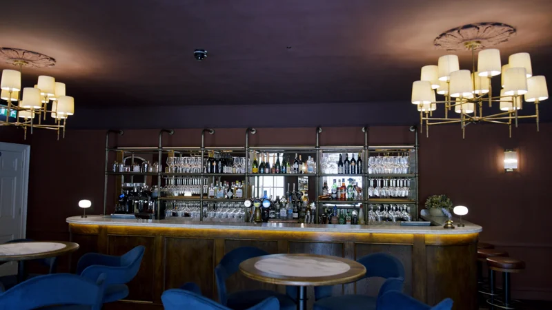 The bar, lit by wall lights